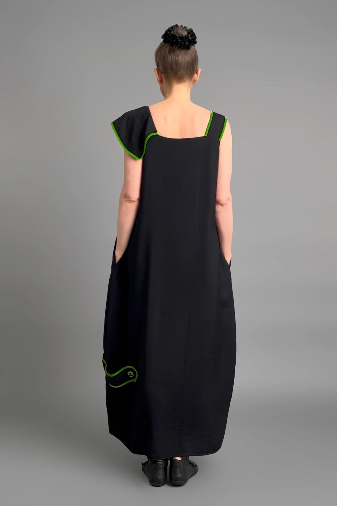 Schwarzes Kleid von LUANI mit grünen Kontrastnähten und Statement-Stickerei im Avantgarde-Stil